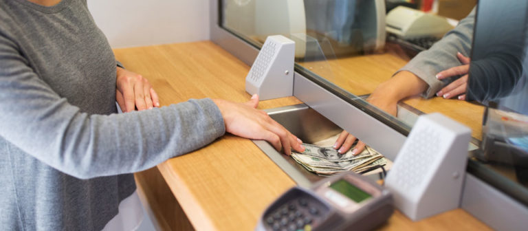 A person completing a banking transaction.